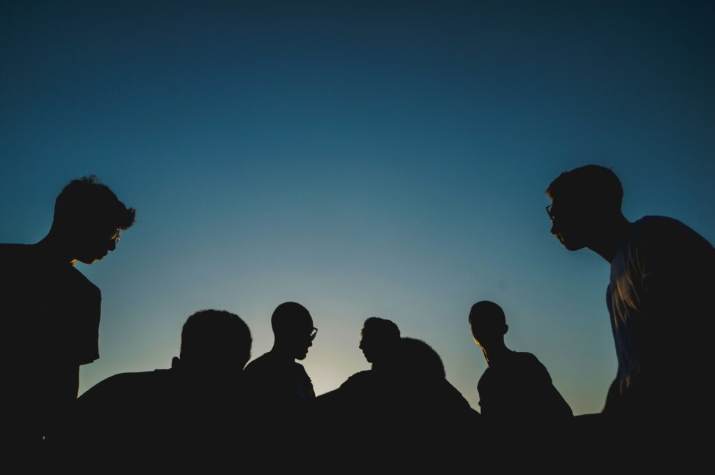 Group of people against a night sky 