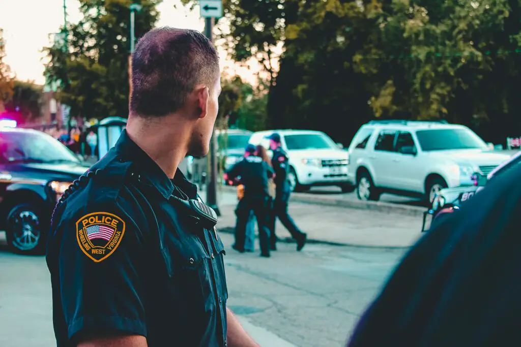 Policer Officer standing in from of a crime scene