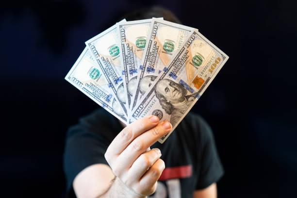 Man holding some counterfeit money notes